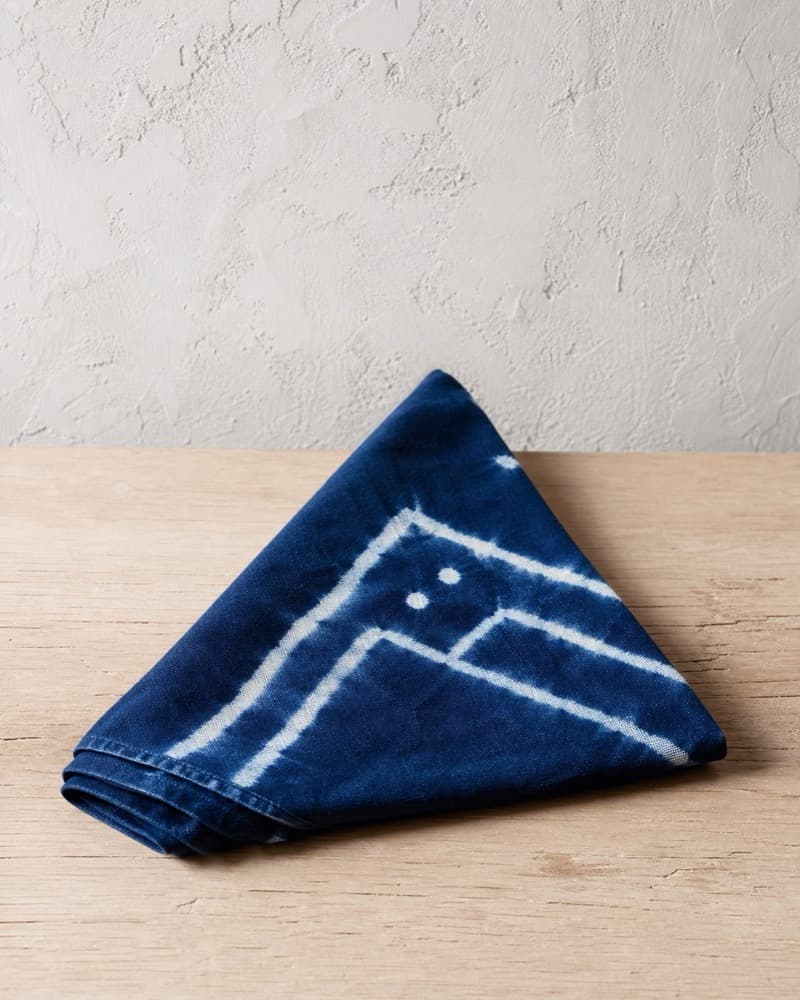 Natural indigo cotton bandana folded into a triangle