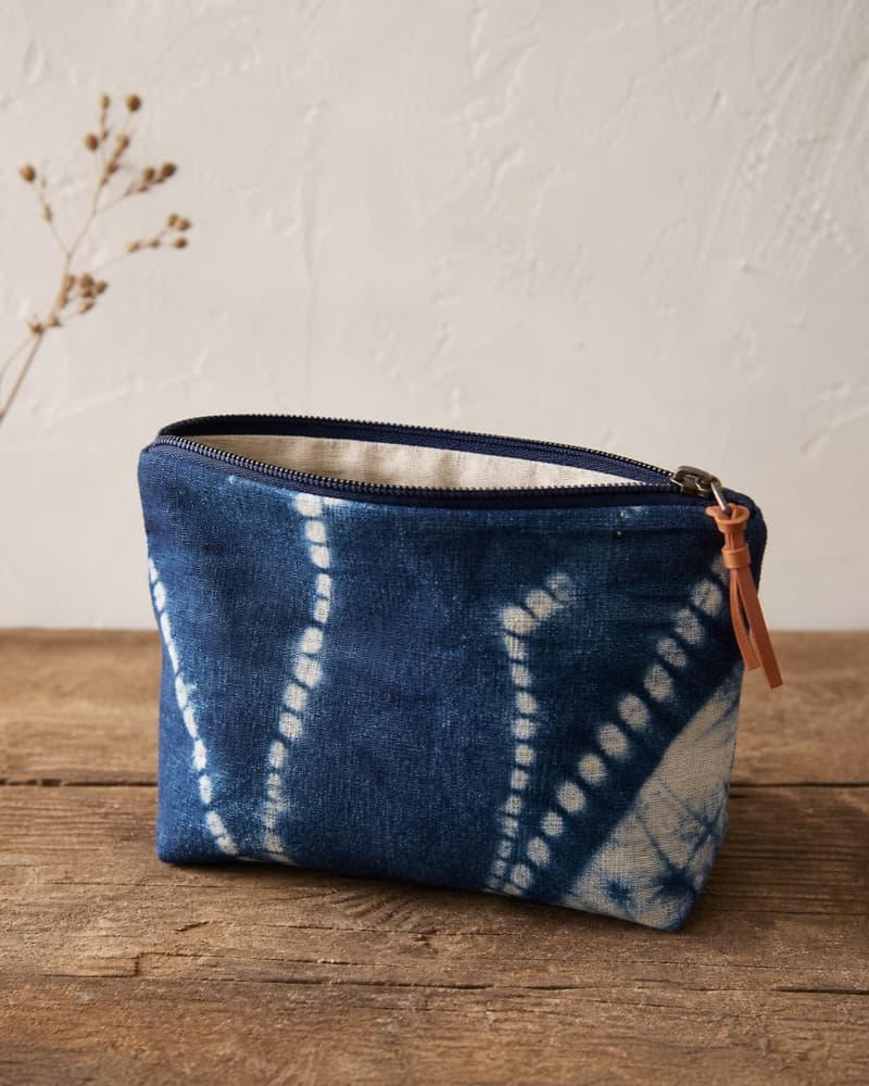 Small natural indigo zip pouch with tan zipper pull